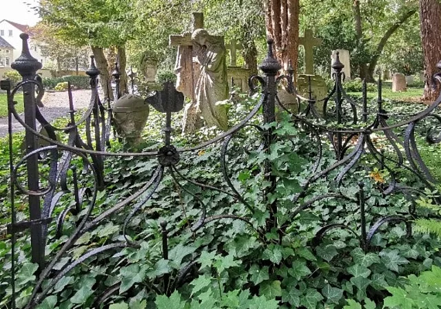 altes Familiengrab mit Geländer und Statue